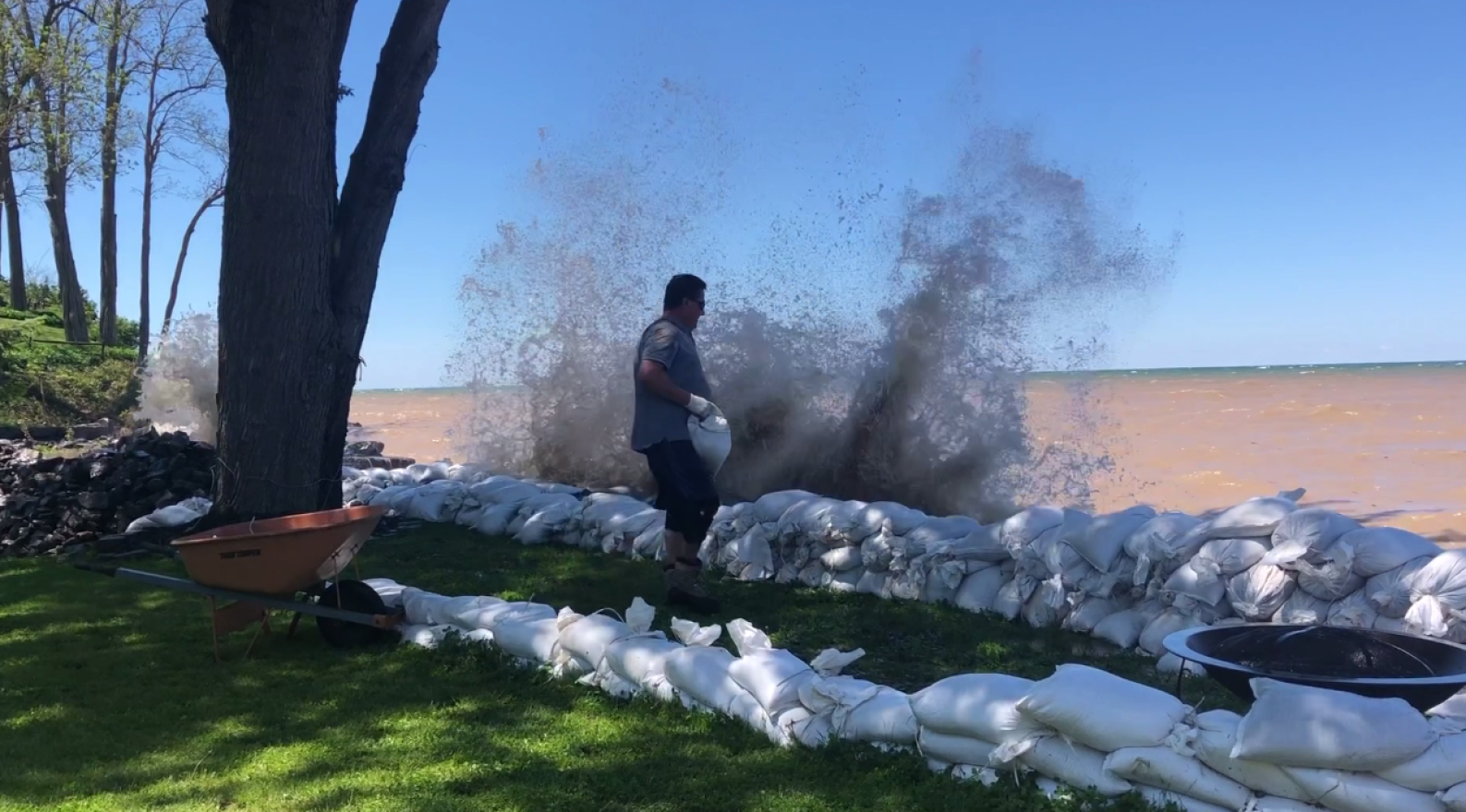 Bill Deasy stacks sandbags on the edge of his property.